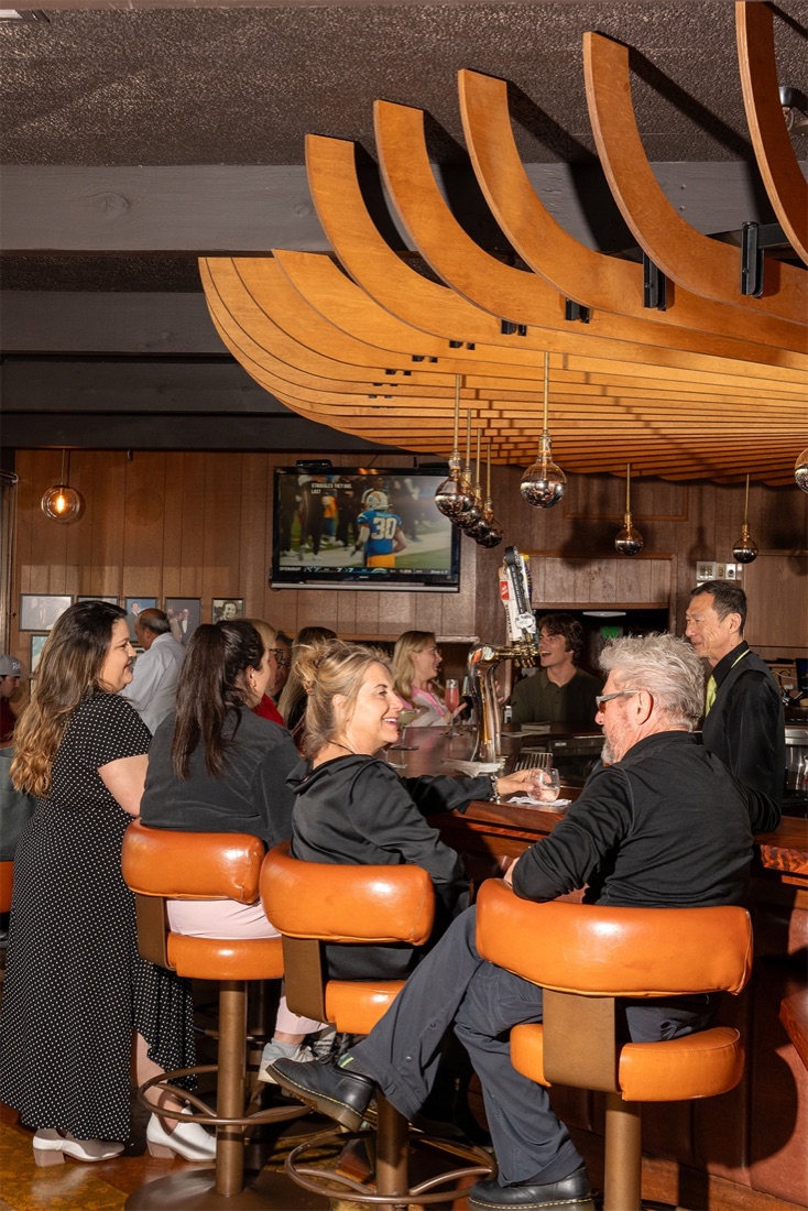 Guests enjoying cocktails at the bar