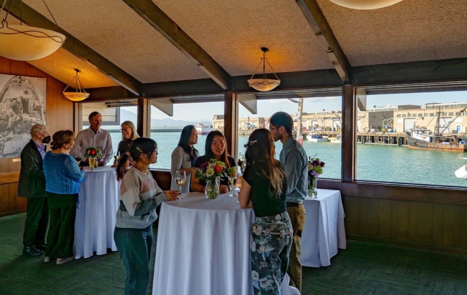 Guests networking with the Bay in view